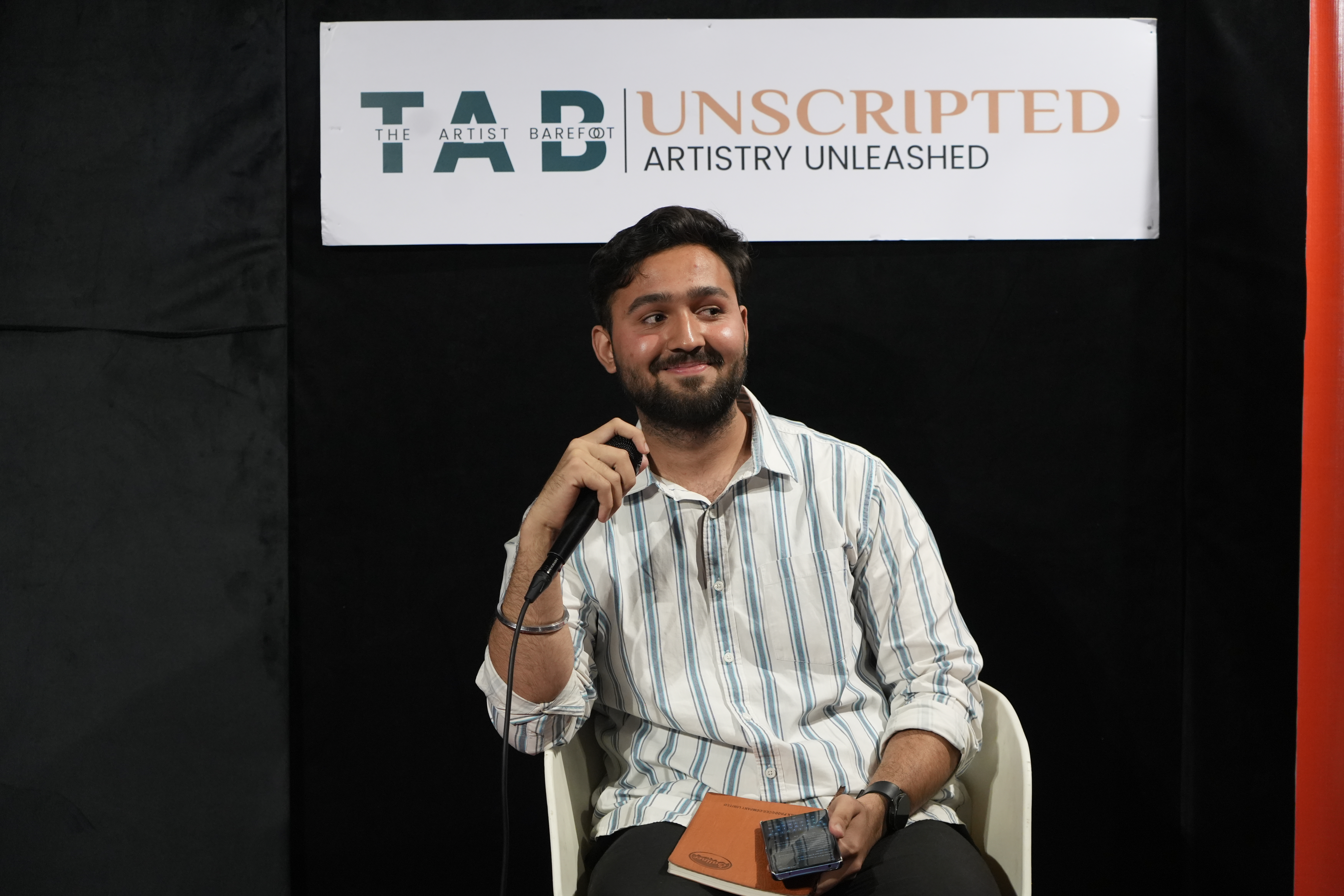 An amateur performer taking the stage during open mic night